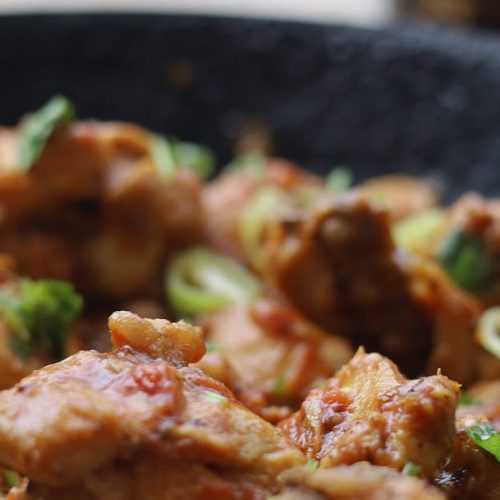 Leckeres Hähnchengericht mit frischem Gemüse und Kräutern in einer Pfanne, ideal für kulinarische Inspiration.