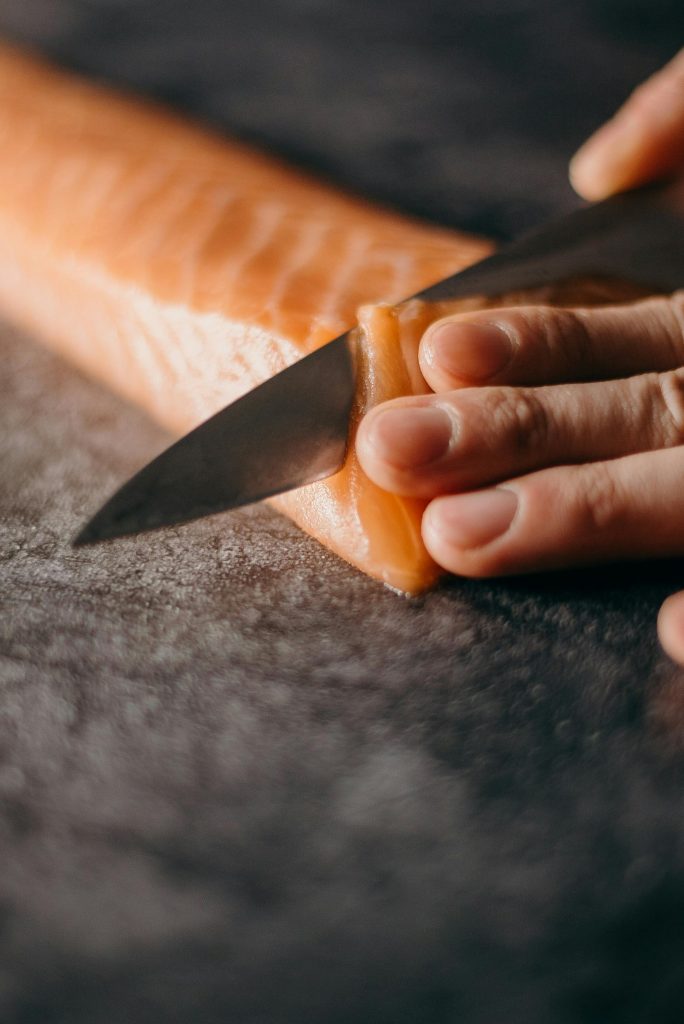 Photo Of Person Slicing Salmon